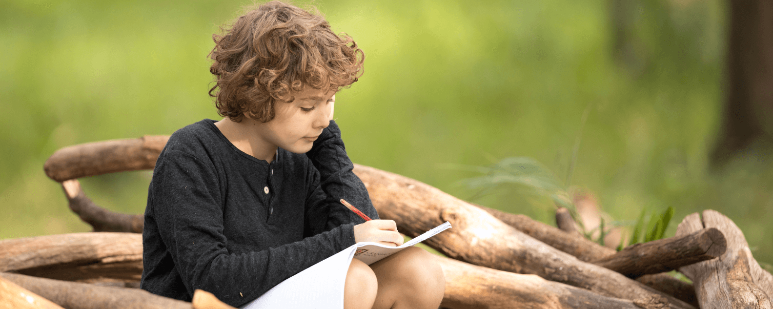 Child sitting down with book.