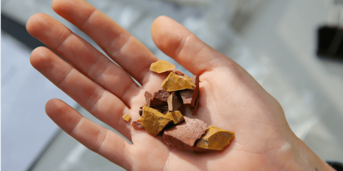 Aboriginal flaked stone artefacts made from imported red silcrete and mudstone left behind by Aboriginal people camping along the banks of Domain Creek in the Paddocks Precinct.