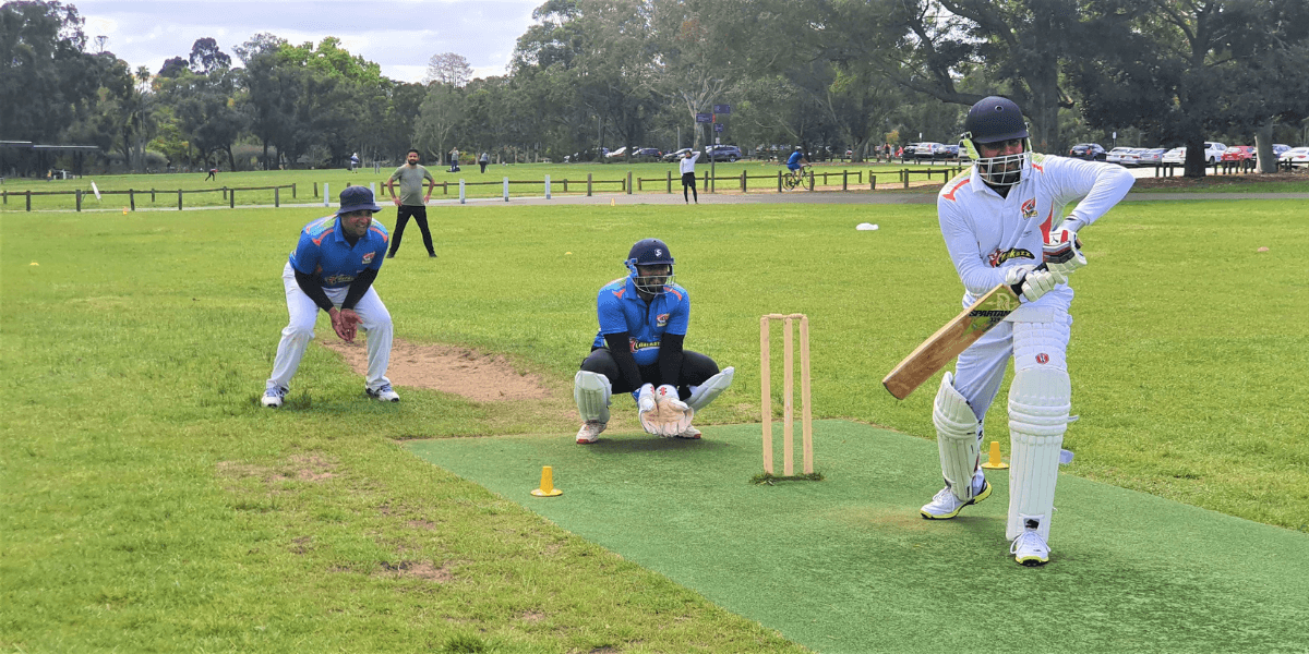 People playing cricket in Parramatta Park.