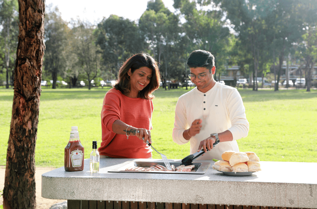 Woman and man having a barbecue. 